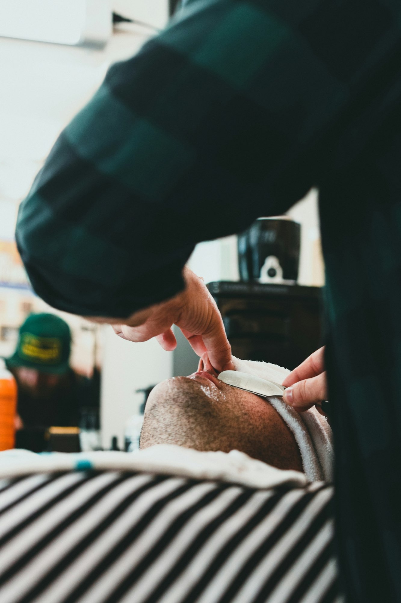 A barber giving a hot-towel straight-razor shave